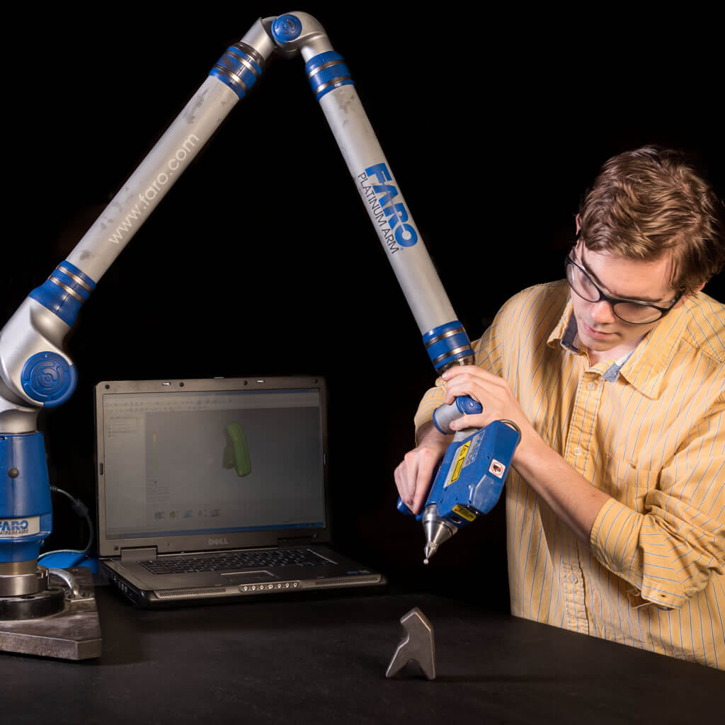 Worker using robotic arm.